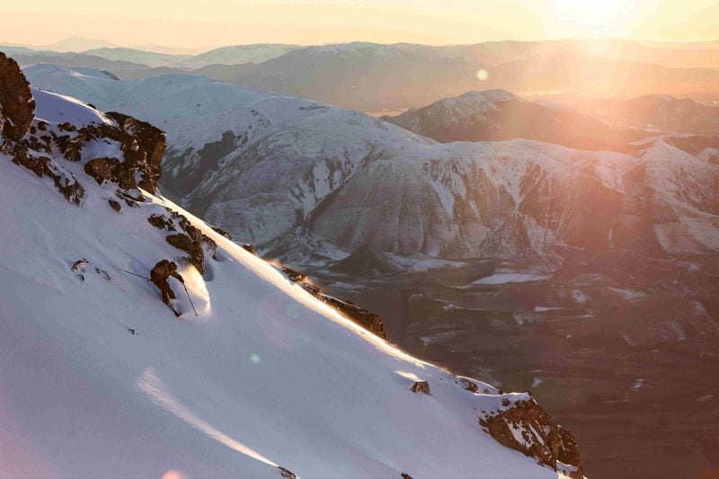 Skier in Mt Hutt backcountry with wide alpine views at sunrise