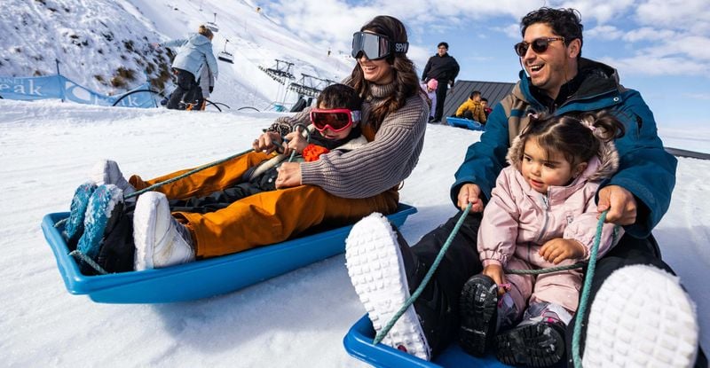 Family sledding at Coronet Peak.