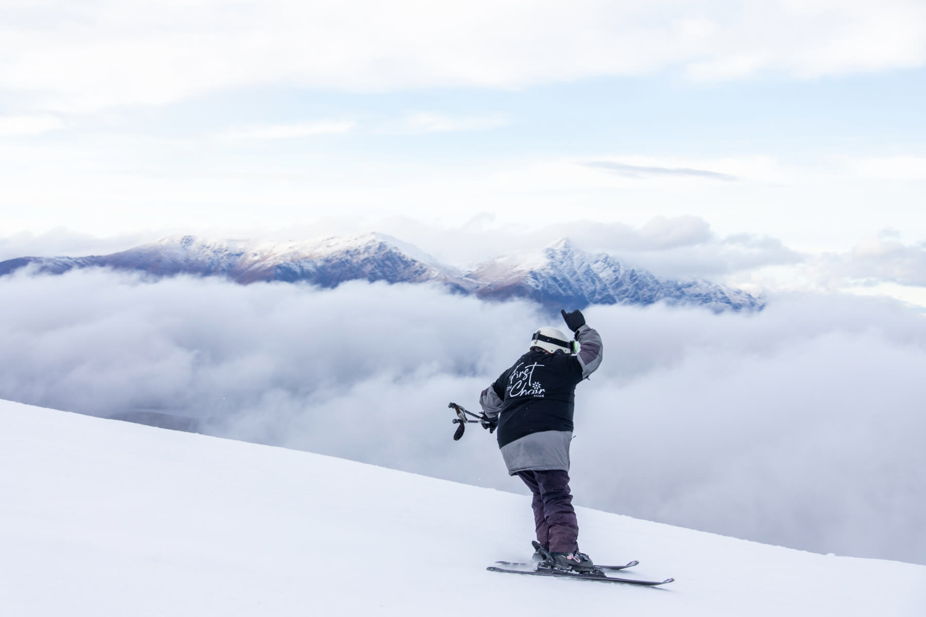 Person skiing above the clouds.