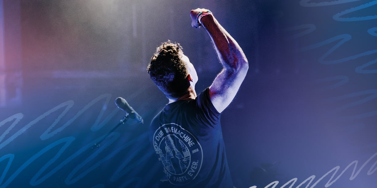 DJ with arm raised in the air.