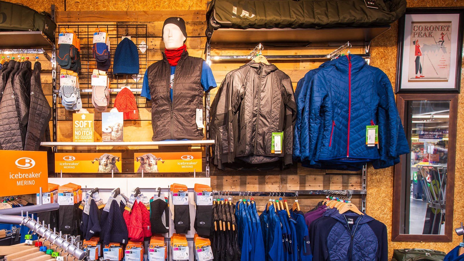 Outdoor clothing and accessories hung up in a retail shop..