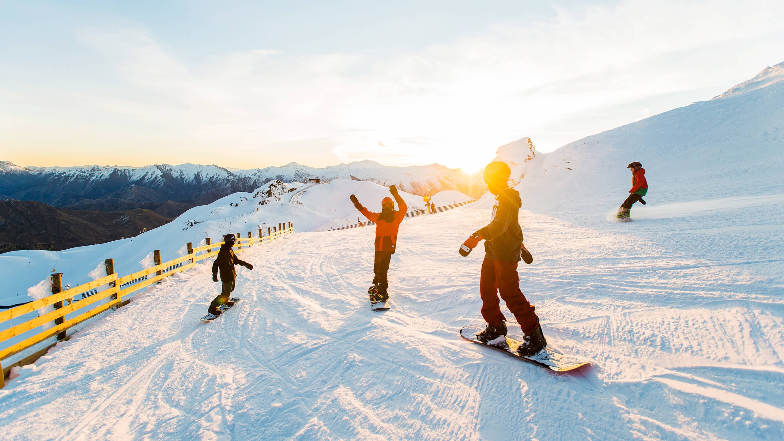 People skiing as the sunsets.
